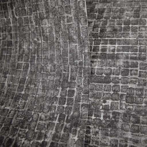 Kopott szőnyegre emlékeztető szabálytalan változatos árnyalatú négyzetek mintája fekete szürke és antracit tónus tapéta