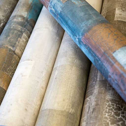 Festékrétegek átfedésében repedezett csillámló felületű töredezett grafikus minta homokszín bézs szürkésbézs és fehér tónus tapéta