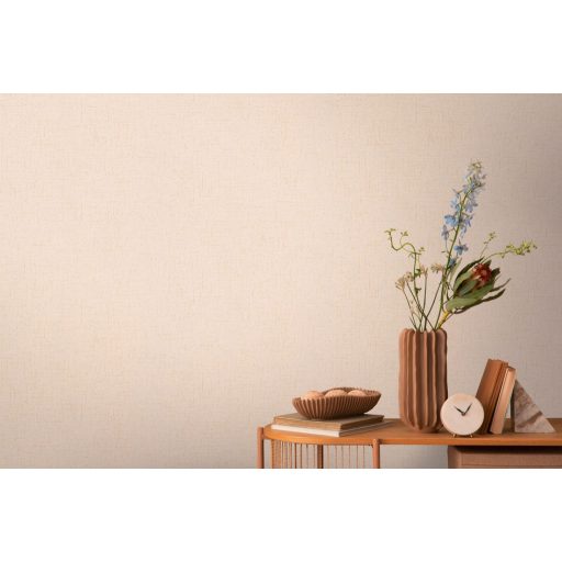 Apró szemcsés texturált egyszínű minta finom fénnyel halvány rózsaszín és arany/bézsarany tónus tapéta